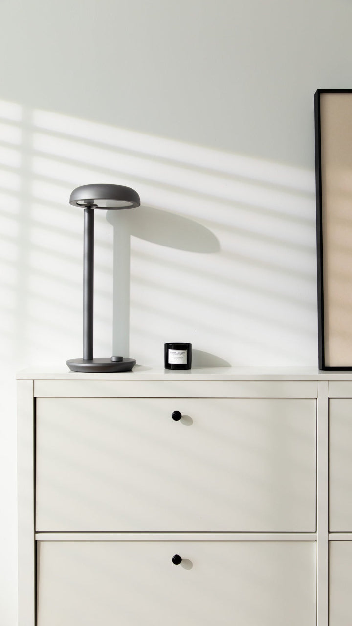 Forecee Desk Lamp placed on a minimalist white shelf, fitting seamlessly into modern home decor.