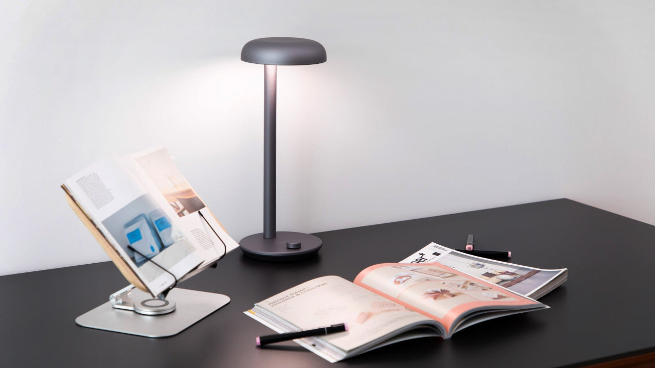 Forecee Desk Lamp at 5000K color temperature, lighting a modern workspace with book and magazine for bright, productive focus.